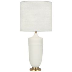 a white lamp with a gold base on a white table cloth shade is shown in front of a white background