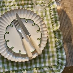 a green and white checkered place setting with silverware