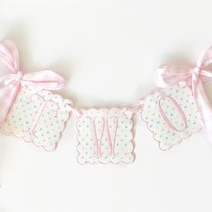 a pink and white banner with polka dots on it