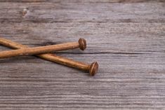 three cinnamon sticks on a wooden surface