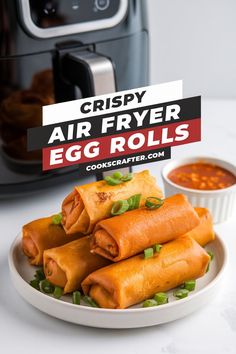 crispy air fryer egg rolls on a plate with dipping sauce in the background