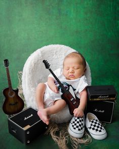 a baby with a guitar and other musical instruments