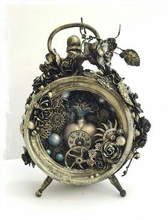 an ornate clock is sitting on a stand