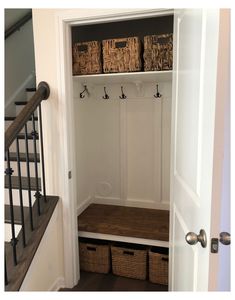 an entry way with some baskets on the shelf