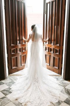 a bride standing in front of an open door