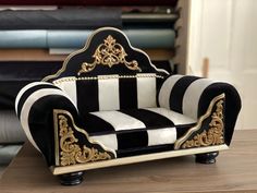 a black and white chair sitting on top of a wooden table