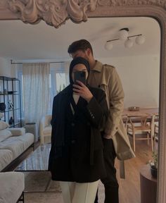 a man taking a selfie in front of a mirror with his reflection on it