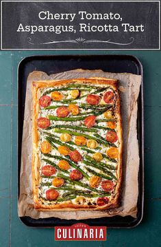 a square pizza with asparagus, tomatoes and cheese