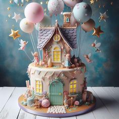 there is a cake with balloons and stars on the top, it has a house in the middle