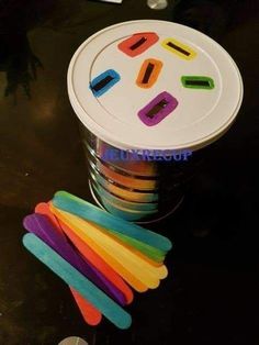 there are many different colored sticks in the cup and one is next to each other