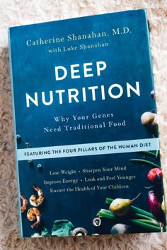 the book deep nutrition is laying on a white carpet