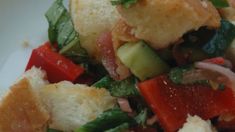 a close up of a plate of food with meat and vegetables on it, including bread croutons