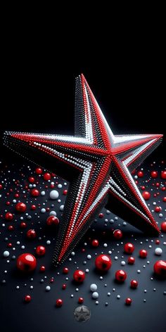 a red and white star surrounded by balls on a black background with space for text