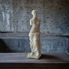 a white statue sitting on top of a table