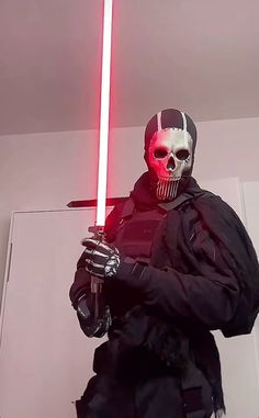 a man with a red light saber in his hand and a skull on his face