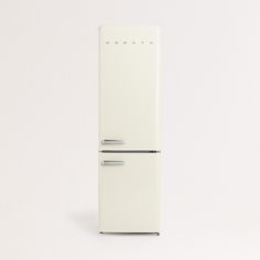 a white refrigerator freezer sitting on top of a white floor next to a wall