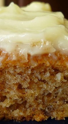 a piece of carrot cake with white frosting