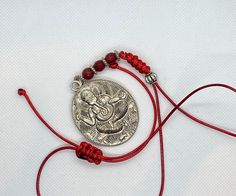 Three different variations of Ganesh:  1) brown and brass micro pave Ganesh elephant crystal tassel green silk cord necklace with malachite accent bead. Adjustable with woven Tibetan knot slide made by me. Wear it long or short.  2) red chord with round silver charm Ganesh with red carnelian beads on red silk cord necklace. Adjustable with woven Tibetan knot slide made by me. Wear it long or short.  3) blue chord silver Ganesh elephant Tibetan charm and tiger eye accent bead. Adjustable with wov Adjustable Gemstone Beads Jewelry For Festivals, Traditional Jewelry With Sliding Knot For Festival, Traditional Adjustable Cord Festival Jewelry, Bohemian Necklace With Adjustable Silk Cord, Handmade Adjustable Silk Cord Necklaces, Adjustable Bohemian Necklace With Silk Cord, Bohemian Silk Cord Adjustable Necklaces, Bohemian Adjustable Silk Cord Necklace, Handmade Silk Cord Necklaces As Gift