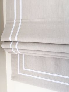 a close up of a roman blind with white lines on the top and bottom part