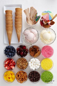 an ice cream sundae with toppings in bowls