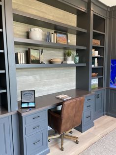 an office with built in bookcases and desk