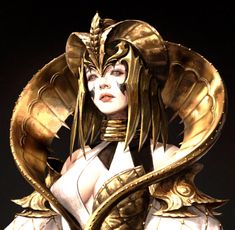 a woman dressed in white and gold with a snake around her neck