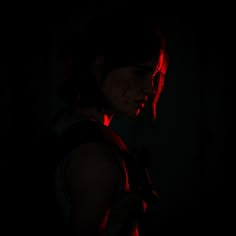 a woman standing in the dark with blood on her face