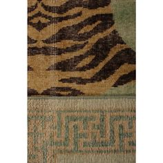 an animal print rug with green and brown colors