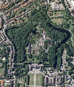 an aerial view of a park with lots of trees and buildings in the middle of it