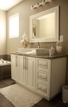 a bathroom with a sink, mirror and bathtub