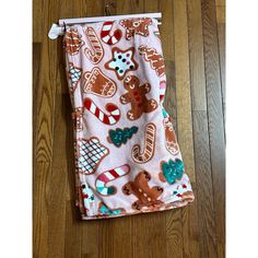 a pair of leggings with gingerbread cookies and candy canes on them