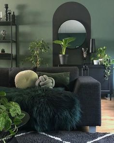 a living room filled with furniture and plants