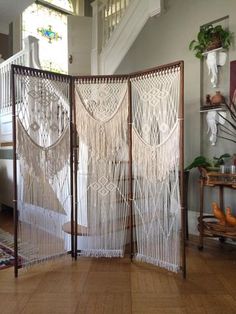 a room divider made out of macrament yarn in front of a staircase