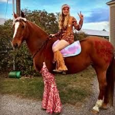 a woman sitting on top of a brown horse