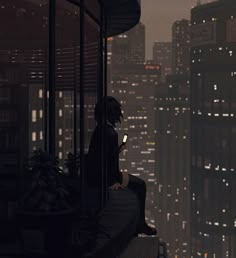 a man sitting on top of a building looking at his cell phone in the city