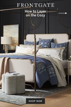 a bed with blue and white comforters on it