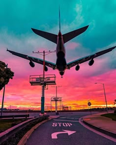 an airplane taking off into the sky at sunset