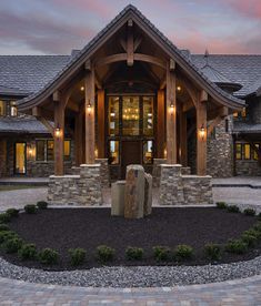 a large house with stone and wood accents