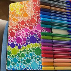 an art journal with colored pencils and markers