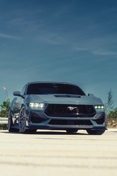 the front end of a gray sports car