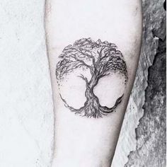 a tree tattoo on the left leg