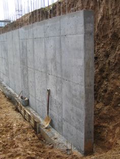 a large concrete block sitting in the middle of a construction site with tools sticking out of it