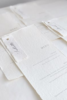 several pieces of white paper with writing on them