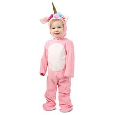 a toddler in a pink unicorn onesuit with a horn on it's head