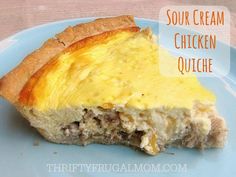 a piece of quiche on a blue plate with the words sour cream chicken quiche