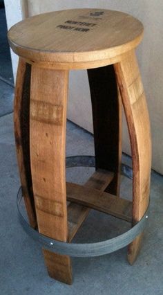 a wooden stool sitting on top of a cement floor