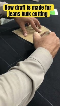 a person cutting paper with scissors on a table