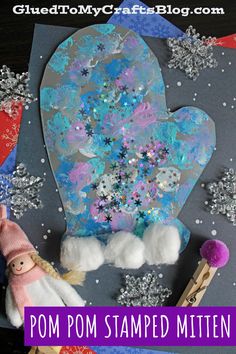 a paper plate with snowflakes on it next to some crafting supplies and the words pom - pom stamped mitten