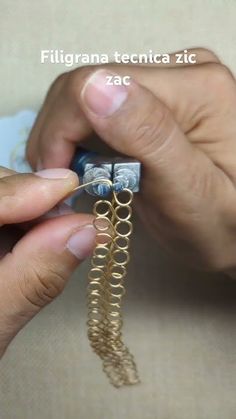 a person is working on some type of jewelry