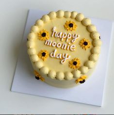 a birthday cake with the words happy moonie day written in frosting on it